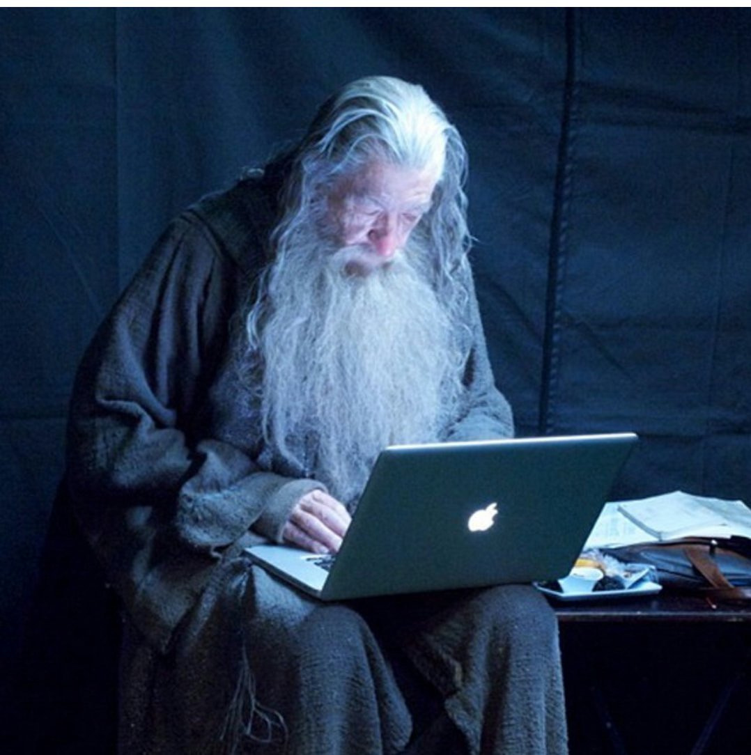 photo of Gandalf takes a break on his MacBook Pro while filming 